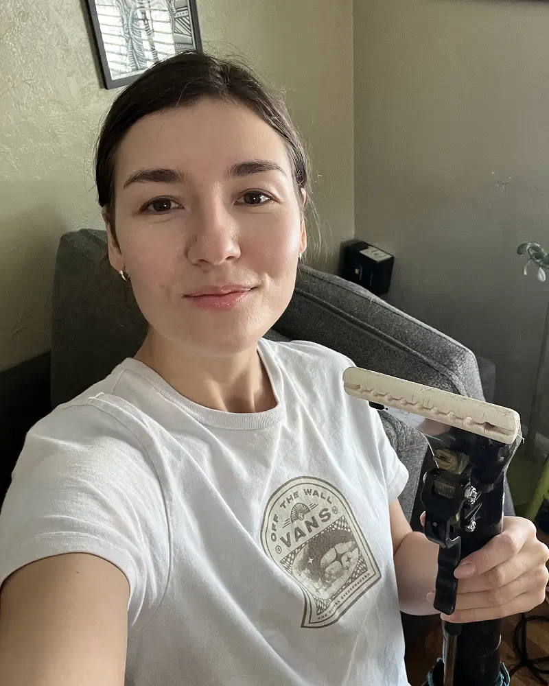 Couch Steamers founder on a couch cleaning job holding an upholstery cleaning wand, reinforcing professional stain removal and deep upholstery cleaning experience.