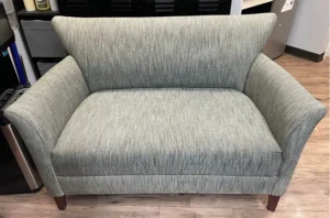 Refreshed gray armchair with even color and lifted fibers after expert fabric cleaning by Couch Steamers