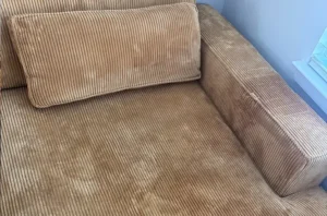 Corduroy couch with visible heavy dirt, staining, and worn surface appearance before upholstery cleaning in Atlanta, GA.