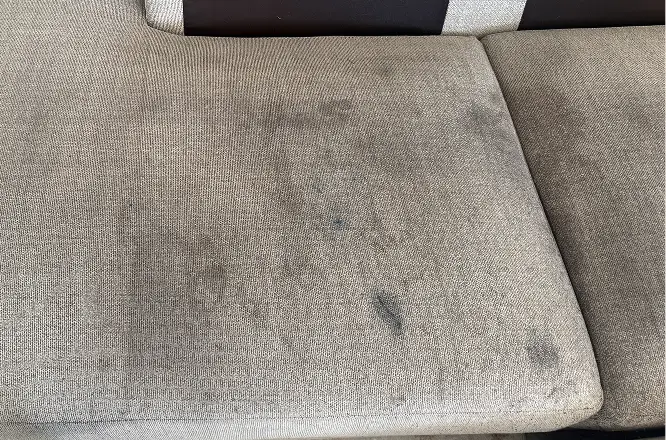 Couch cushion with visible heavy dirt buildup and dark surface soiling before professional upholstery cleaning in Atlanta, GA.