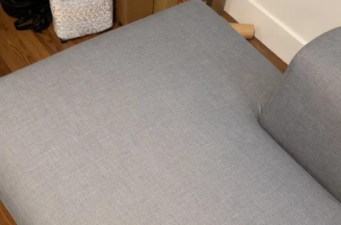 Fabric couch seat after deep steaming upholstery cleaning with a cleaner and more even fabric appearance in Atlanta, GA.