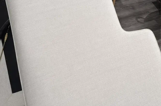 Light fabric couch cushion after general refresh upholstery cleaning with cleaner, brighter, and more even fabric appearance.