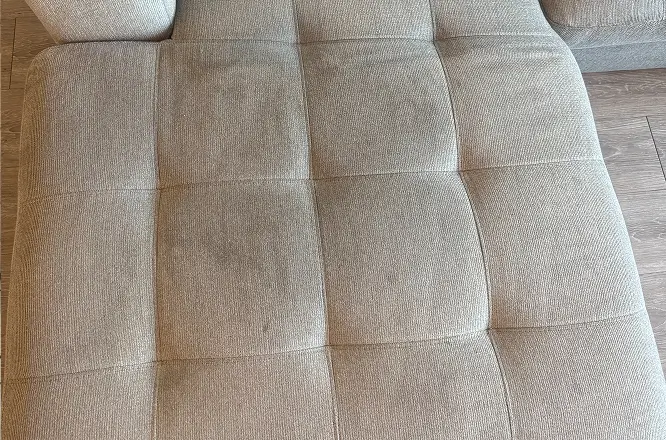 Light sectional couch seating area before general refresh upholstery cleaning, showing surface dullness and light soiling in Raleigh, NC.