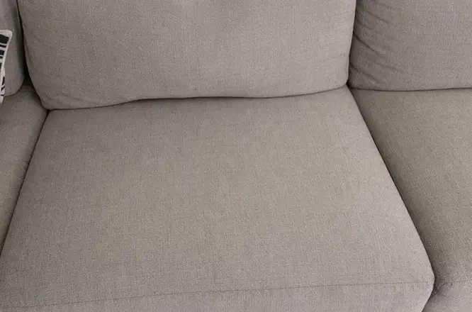 Fabric couch seat cushion after upholstery cleaning with spill stains removed and refreshed fabric appearance.