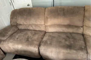 Brown microfiber sofa before sofa cleaning in Portland, OR, with heavy dirt and dark body oil marks on the cushions.
