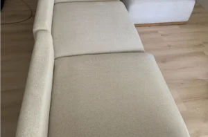 The same beige couch after our upholstery clean, with the spot gone and the fabric back to one even shade.