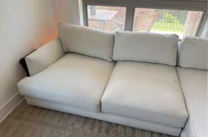 White sectional after couch cleaning services in Denver, CO, with bright, spotless cushions and fabric that feels fresh again.