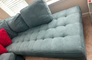 Faded blue sectional with old set in stains before steam upholstery cleaning in Dallas, TX from our fabric cleaning specialists.