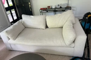The same cream sofa after professional sofa cleaning in Dallas, TX, with pet stains lifted and cushions fresh again.