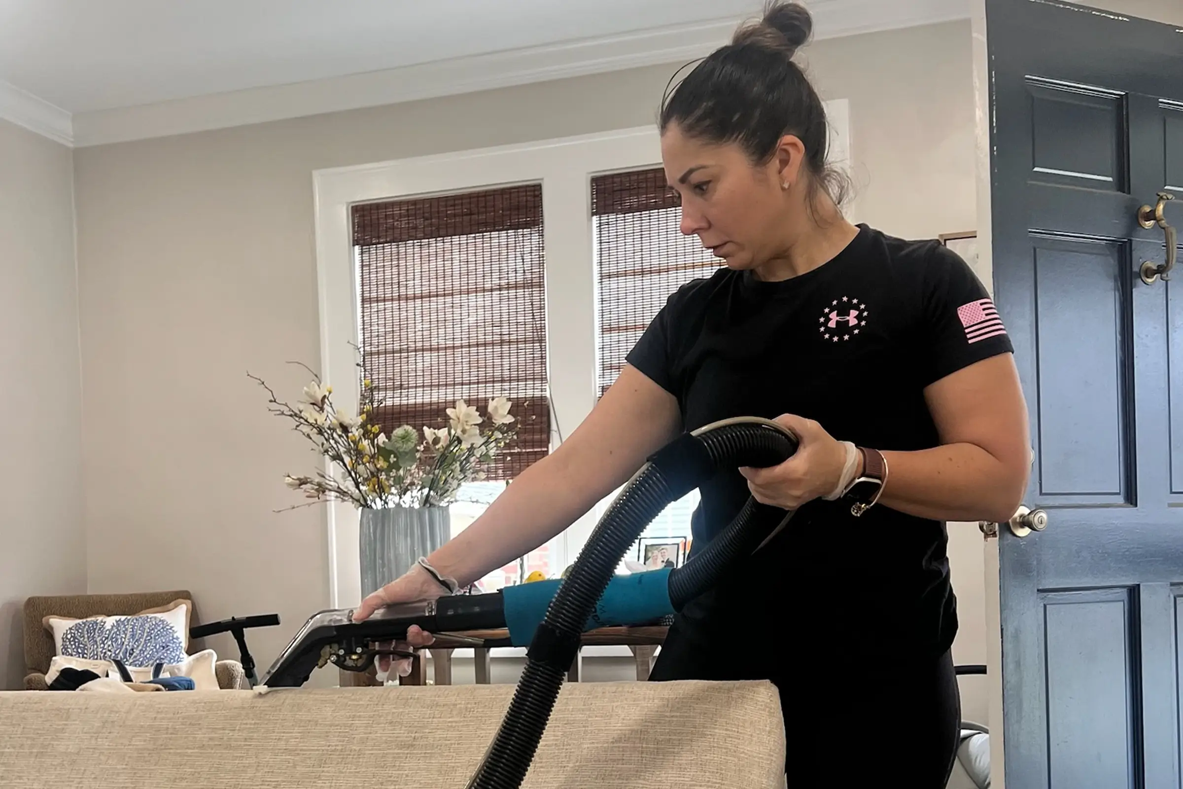Technician performing professional couch cleaning with hot water extraction to extend upholstery fabric life