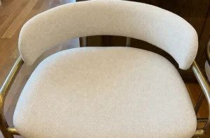 Same cream chair after chair cleaning, with deep stains removed and the fabric looking soft, bright, and fresh.