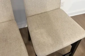Same counter stools after chair cleaning, with marks lifted and the fabric looking even, soft, and like new.