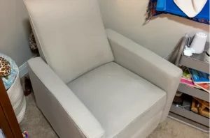 Same gray glider after shampooing chair, with old stains washed out and the seat looking clean and refreshed.