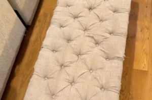 Same tufted bench after shampooing chair, with stains lifted and the fabric looking soft, clean, and even.