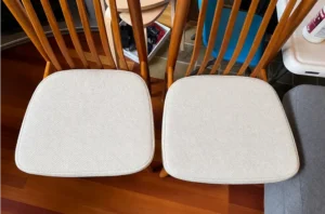 Same dining chair pads after chair cleaning, with dirt washed out and the fabric looking bright and clean.