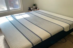 Same striped mattress after mattress cleaning, with old stains lifted and the fabric looking bright and fresh.