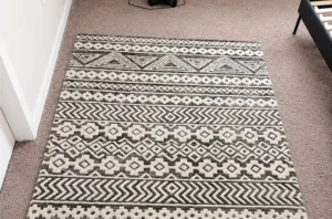 Same patterned rug after rug cleaning, with deep dirt washed out and the black and white design looking sharp.