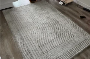 Same beige rug after dog urine rug cleaning, with stains and odor gone and the fabric looking soft and fresh.