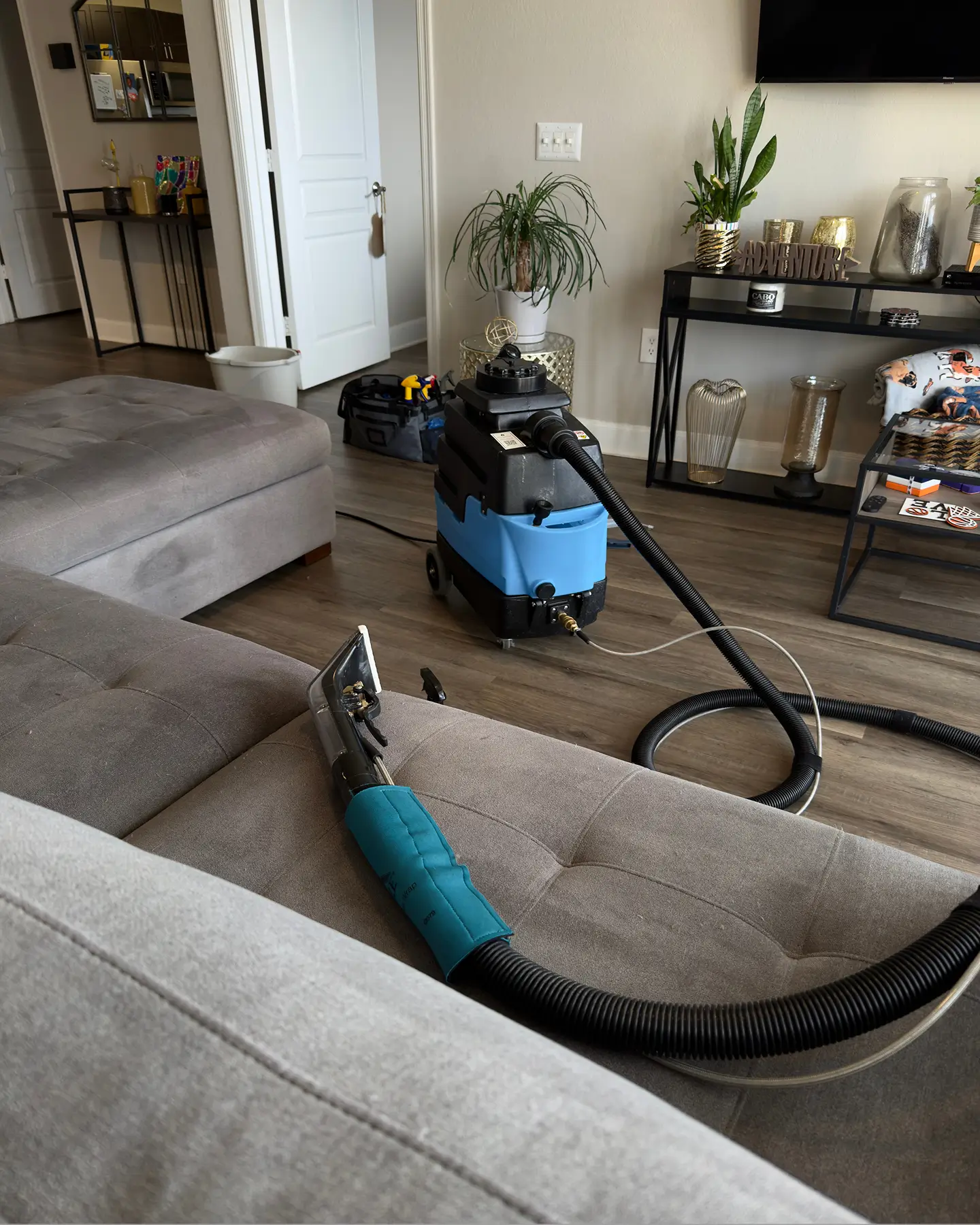 Upholstery wand resting on a gray sectional during Couch Steamers couch cleaning services in Charlotte NC